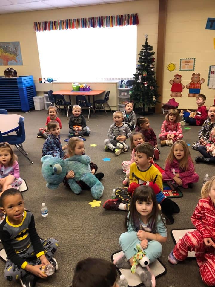 Children sitting on the floor in a classroom