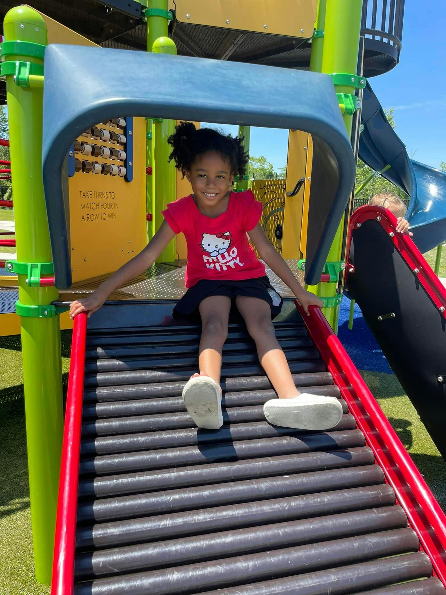 Child sitting on a playground slide