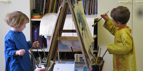 Two children painting at easels