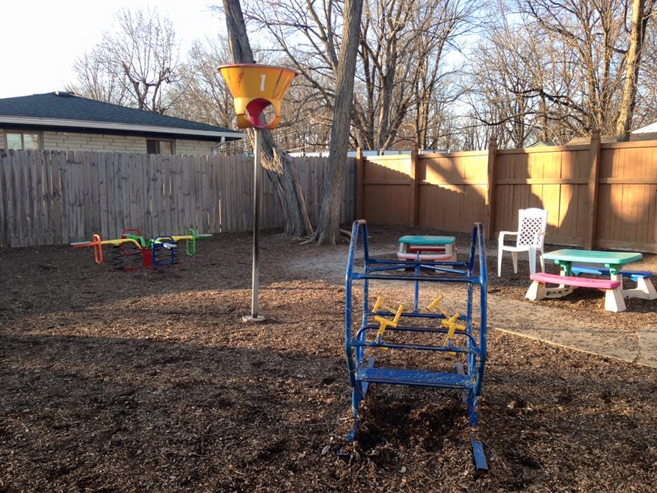 Playground with a seesaw, climbing structure, and picnic table