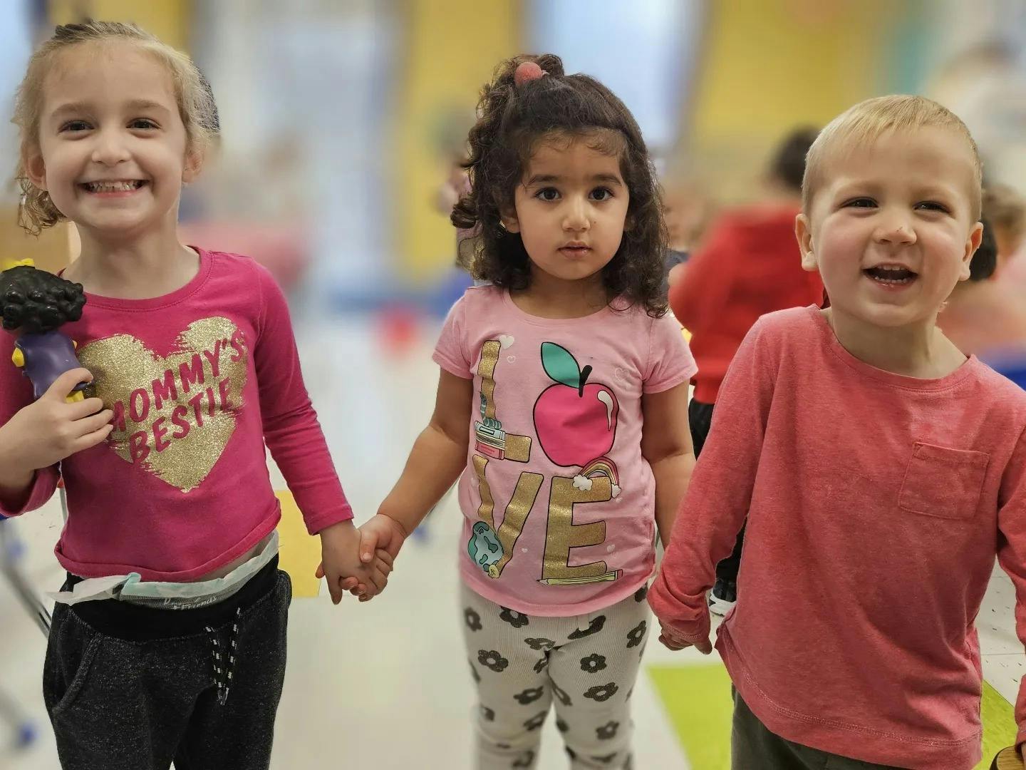 Three children holding hands