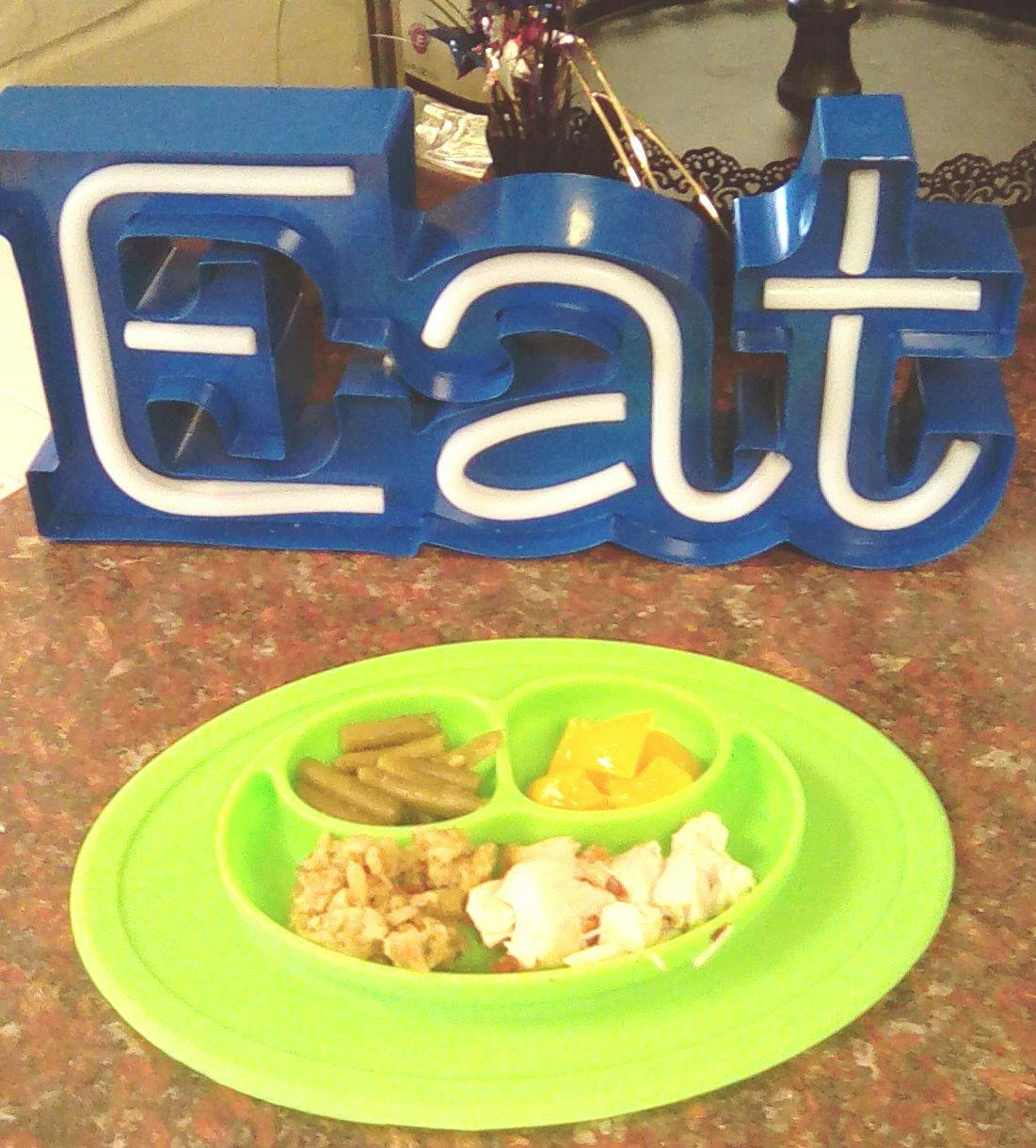 Blue "EAT" sign above a green plate with food portions