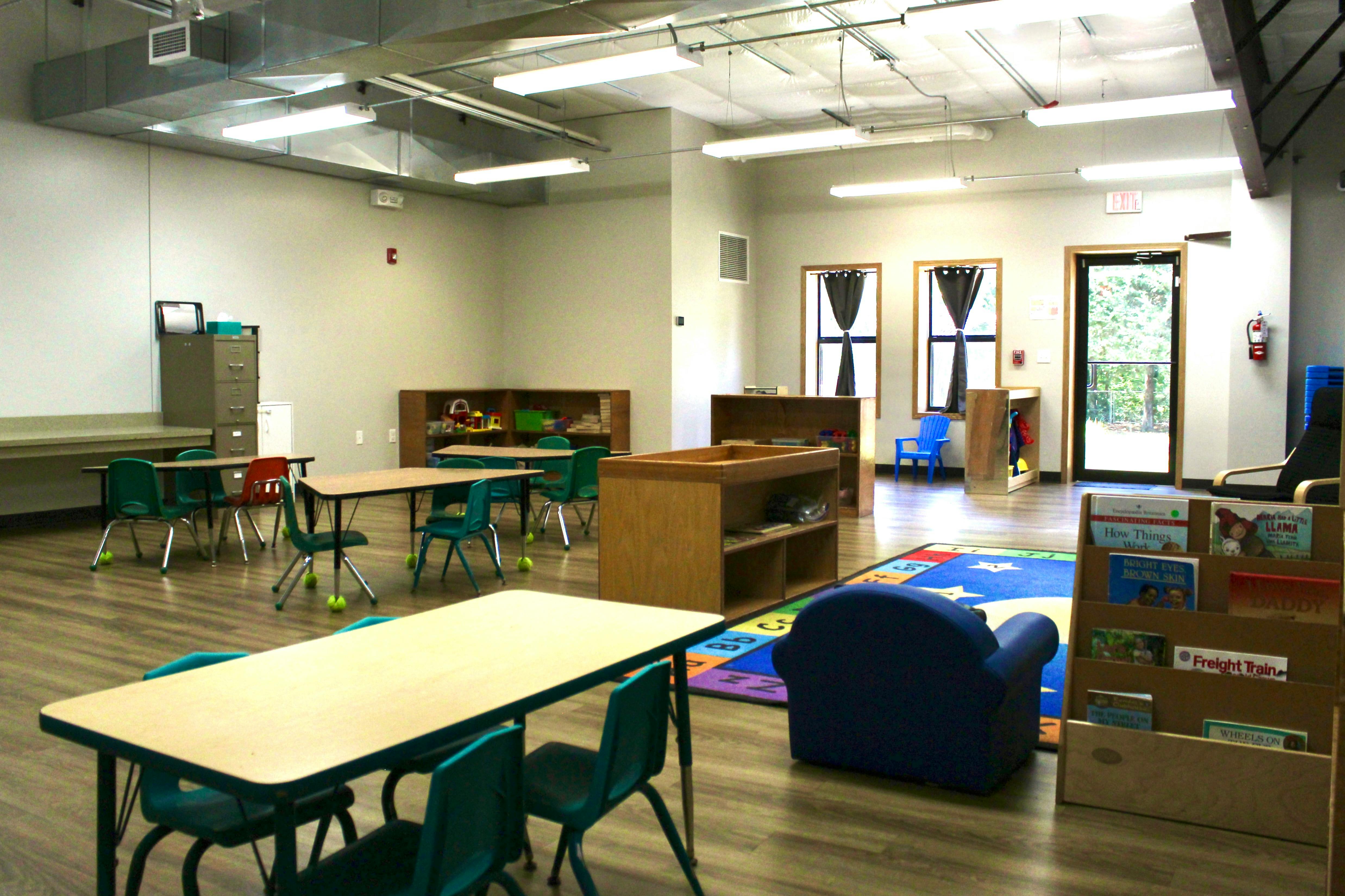 Empty classroom with small tables and chairs
