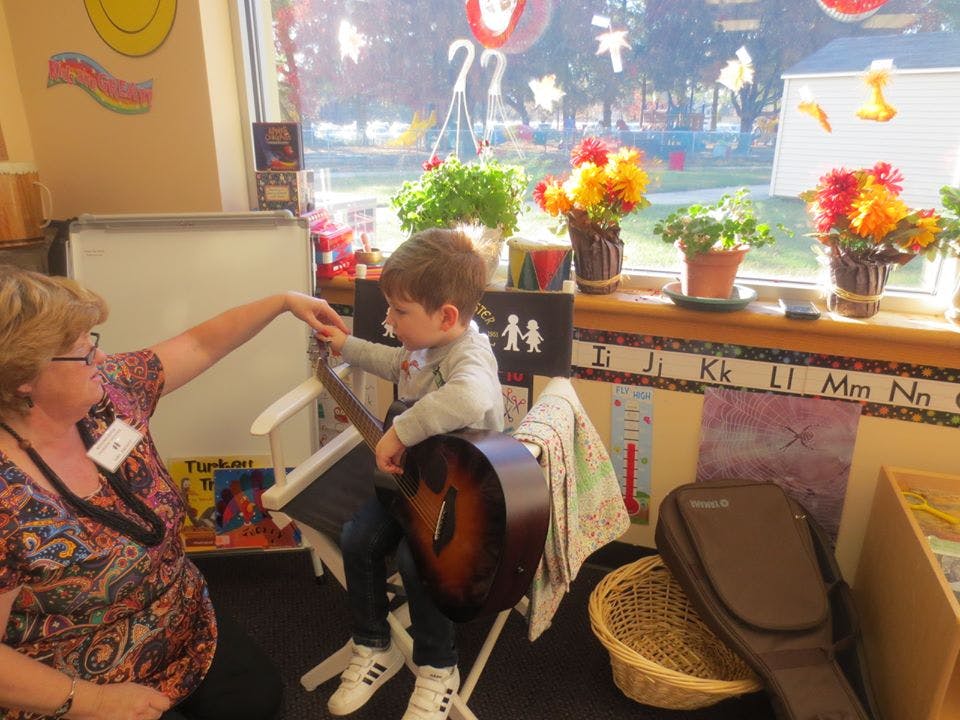 Adult and child with a guitar