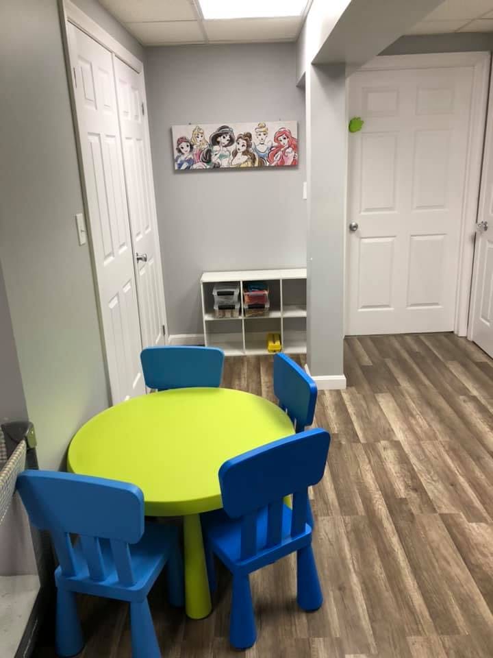 Children's table with four chairs in a room