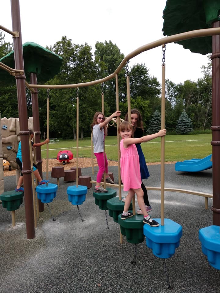 Children playing on a playground climbing structure