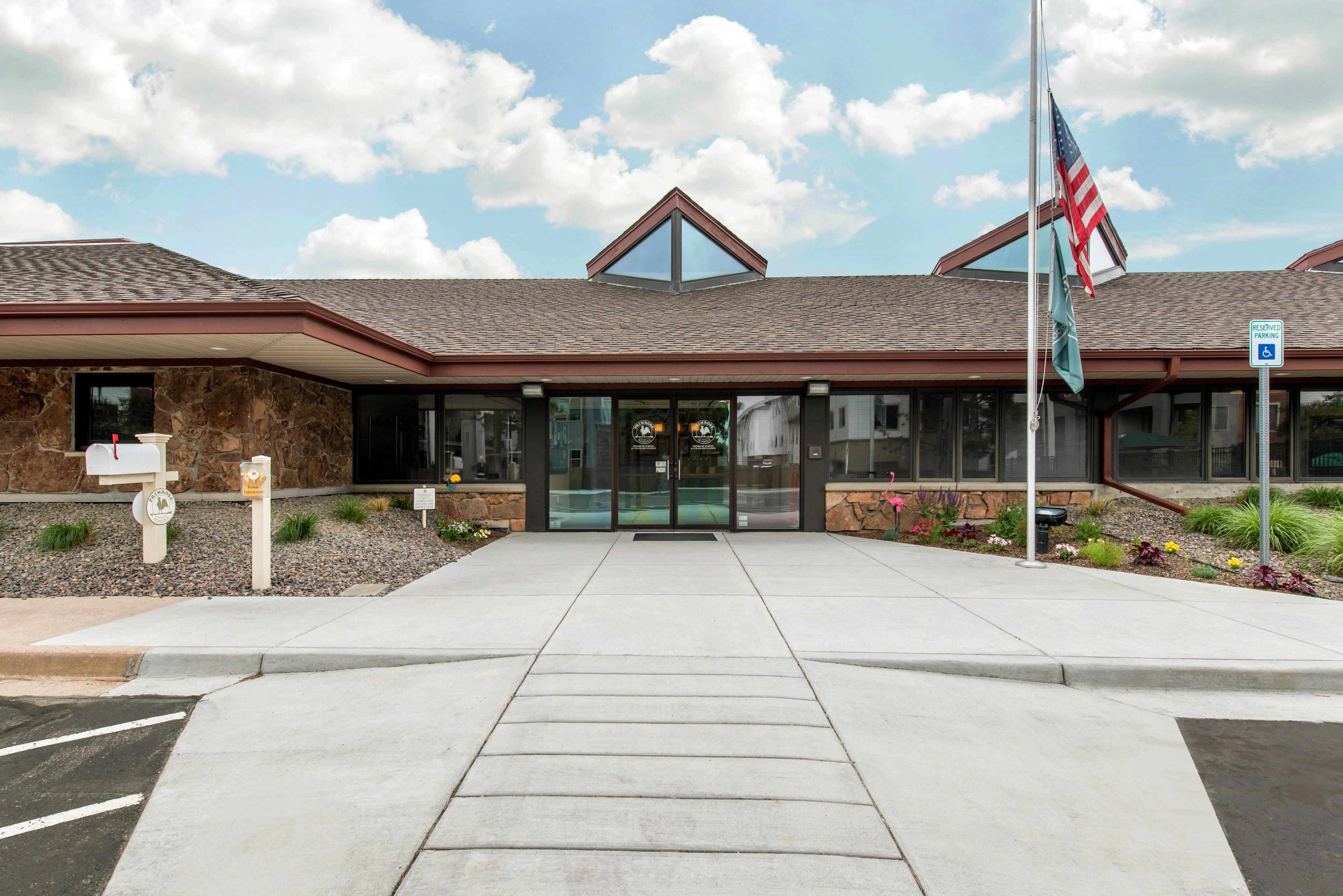 Entrance to a stone building with a flag flying from a flagpole