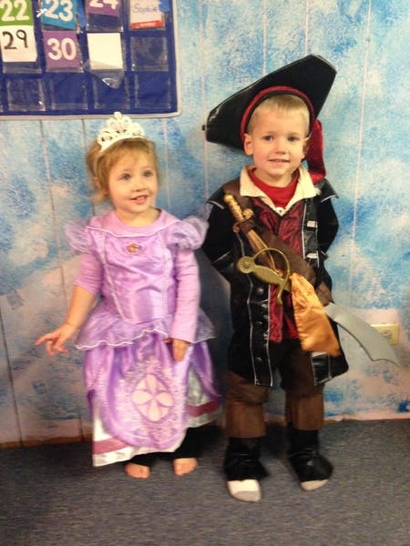 Child in a princess costume and child in a pirate costume standing together