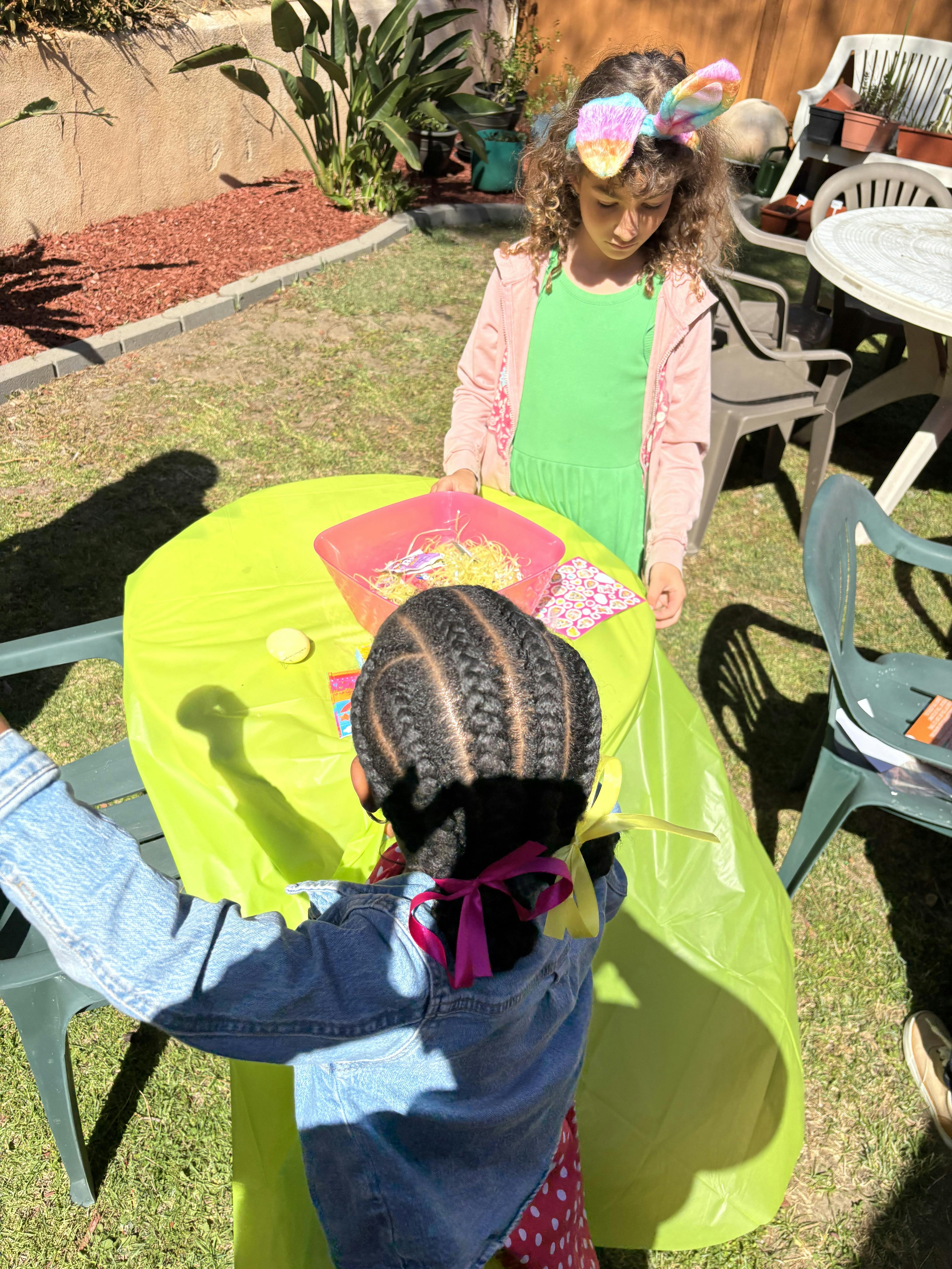 Two children at a table with a pink bowl