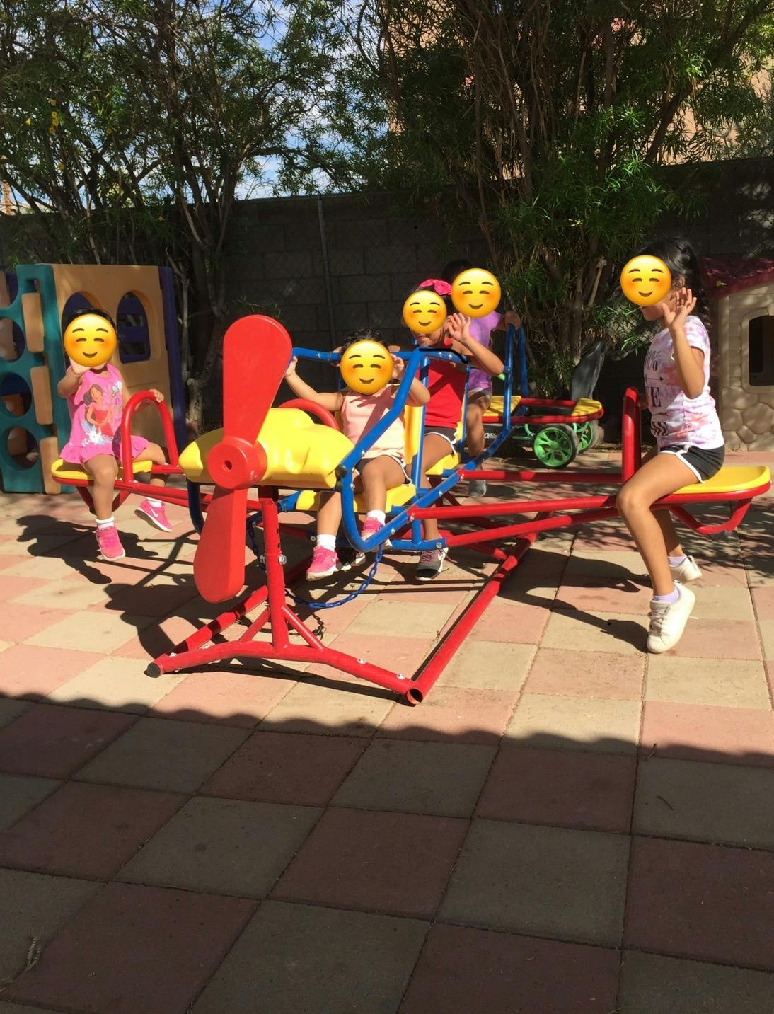 Children playing on a seesaw in a playground