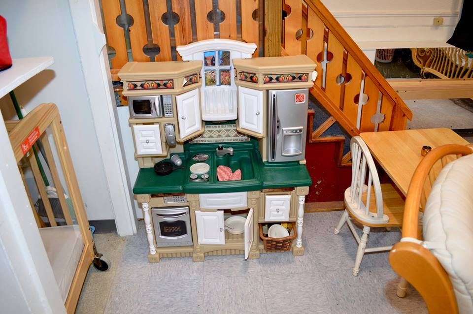 Toy kitchen set with open doors and accessories
