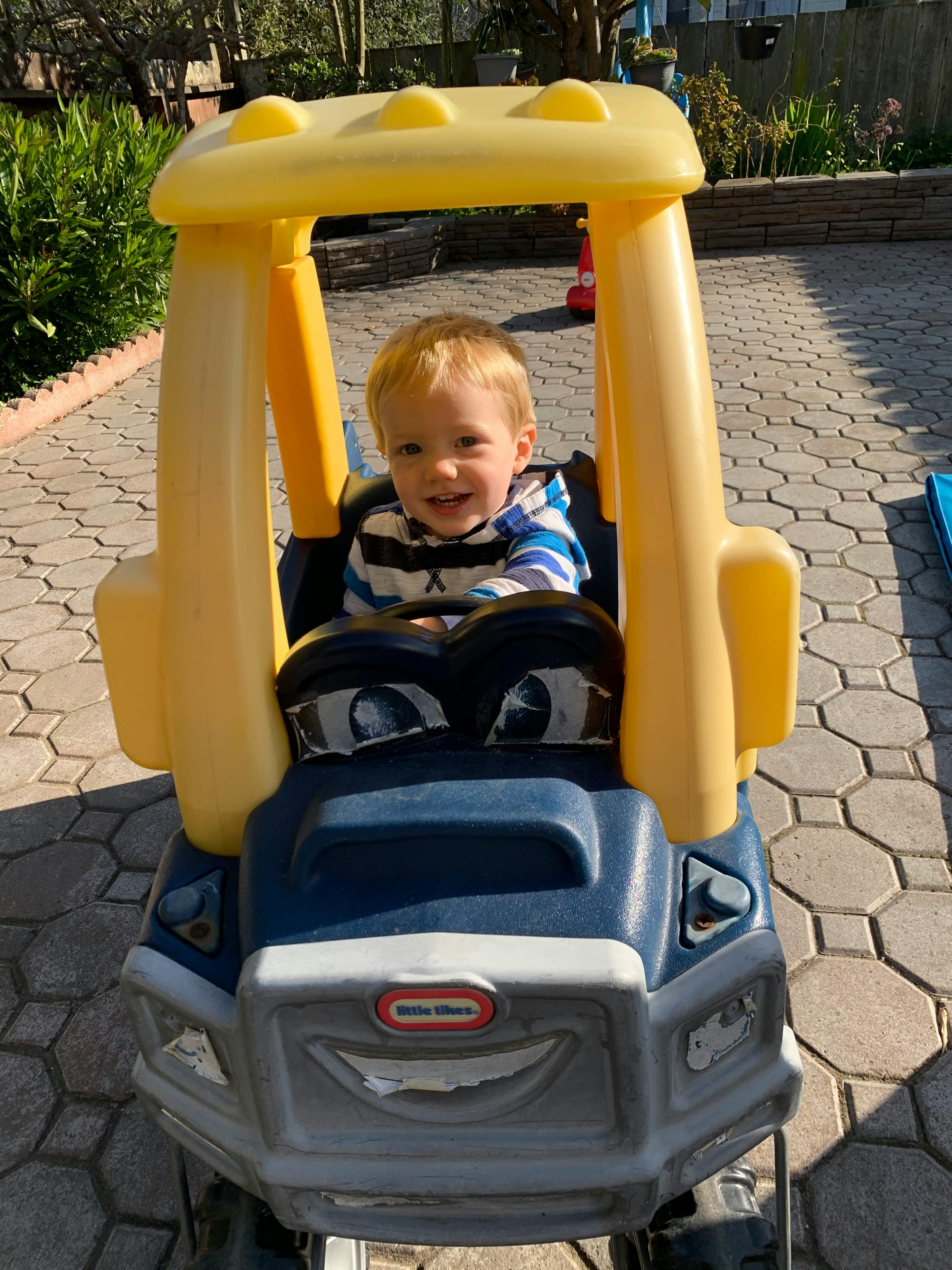 Child in a toy car
