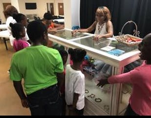 Adult and children looking at items in a display case