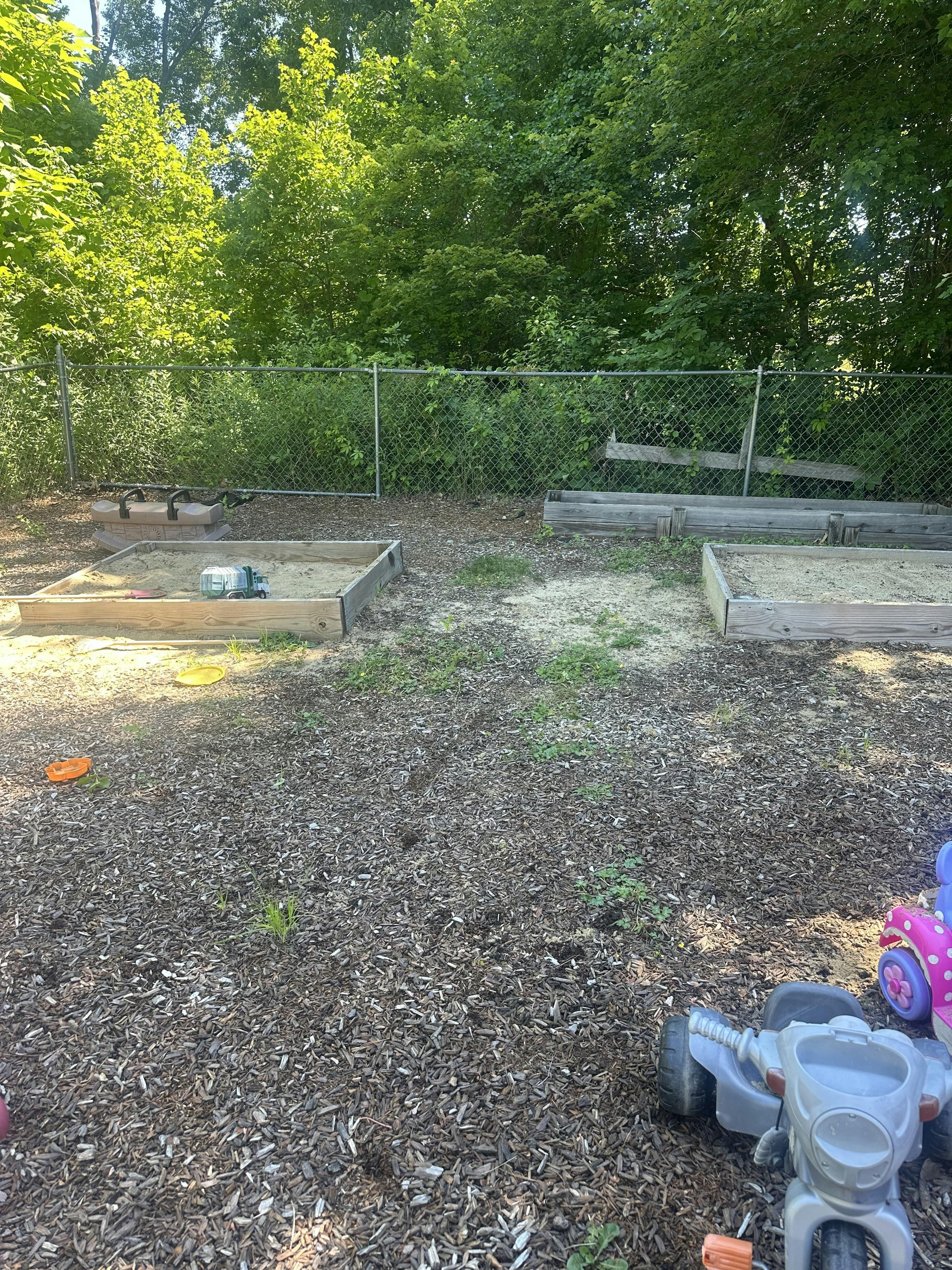 Wooden sandboxes in a backyard playground area