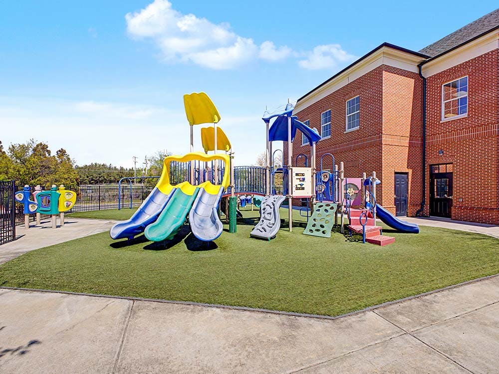 A colorful playground with multiple slides and climbing structures