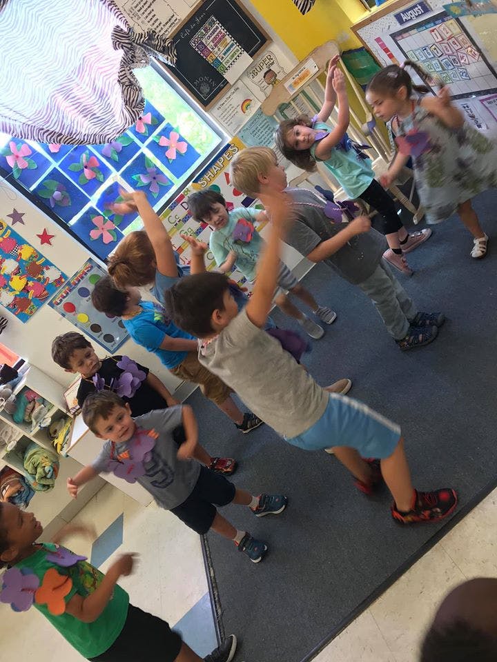 Children dancing in a classroom