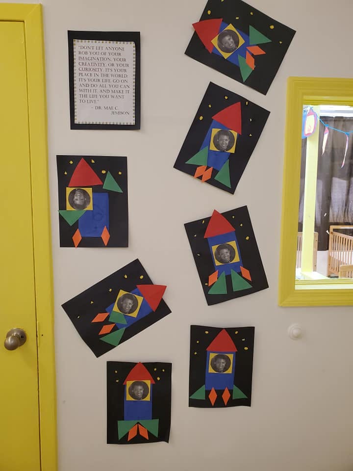 Children's rocket ship crafts with photos of children in the windows