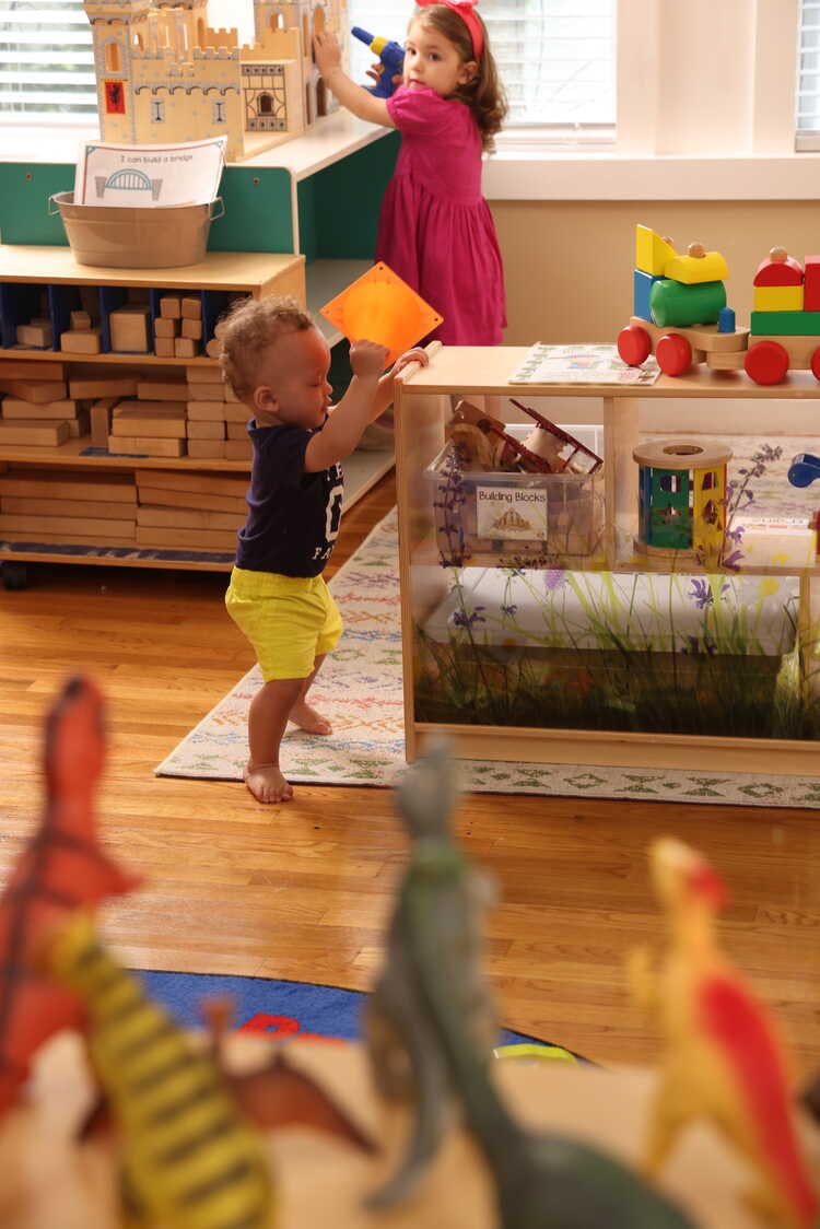 Two children playing with toys in a room