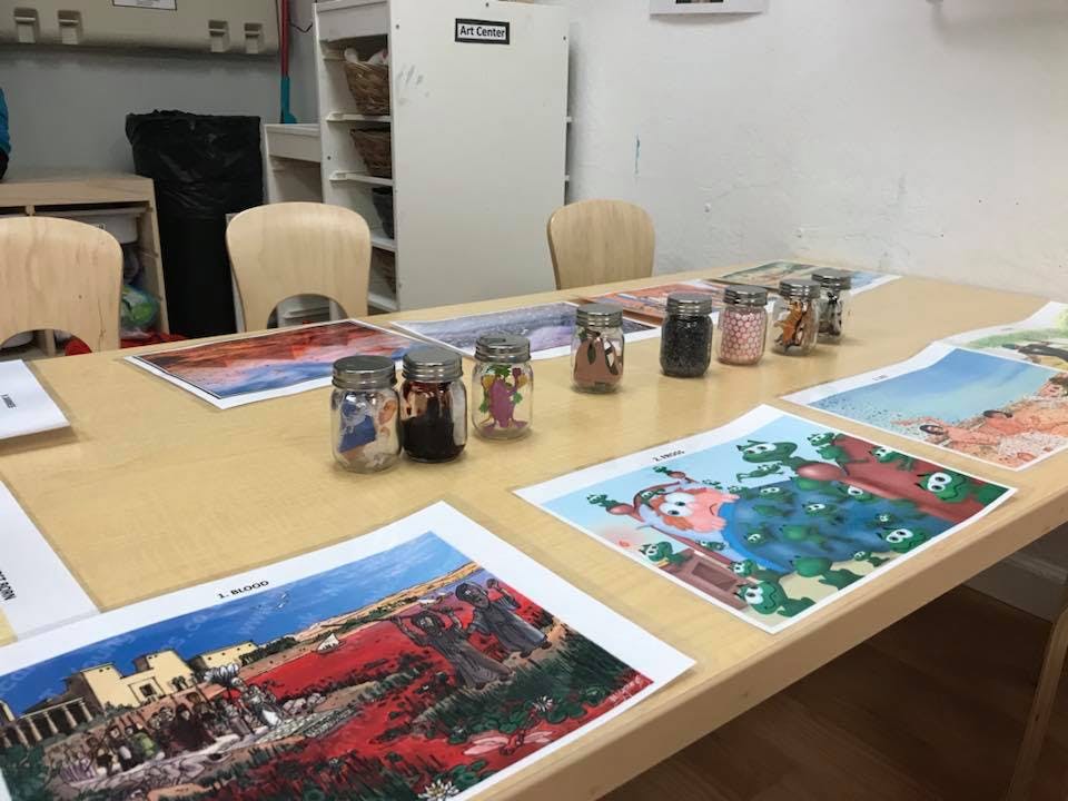 Table with art prints and jars of small items