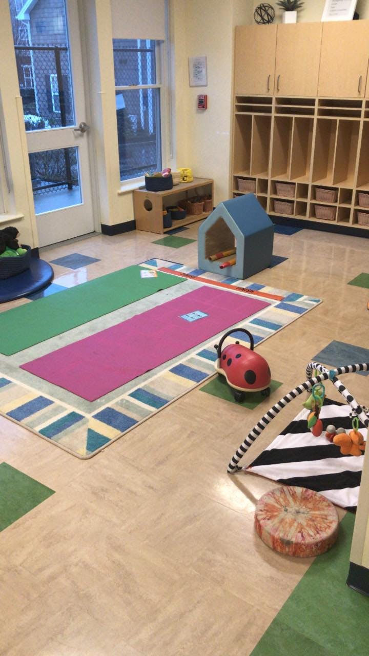 Playroom with colorful rugs, cubbies, and children's toys