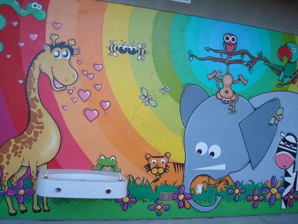Mural of a giraffe, elephant, zebra, tiger, frog, and other animals