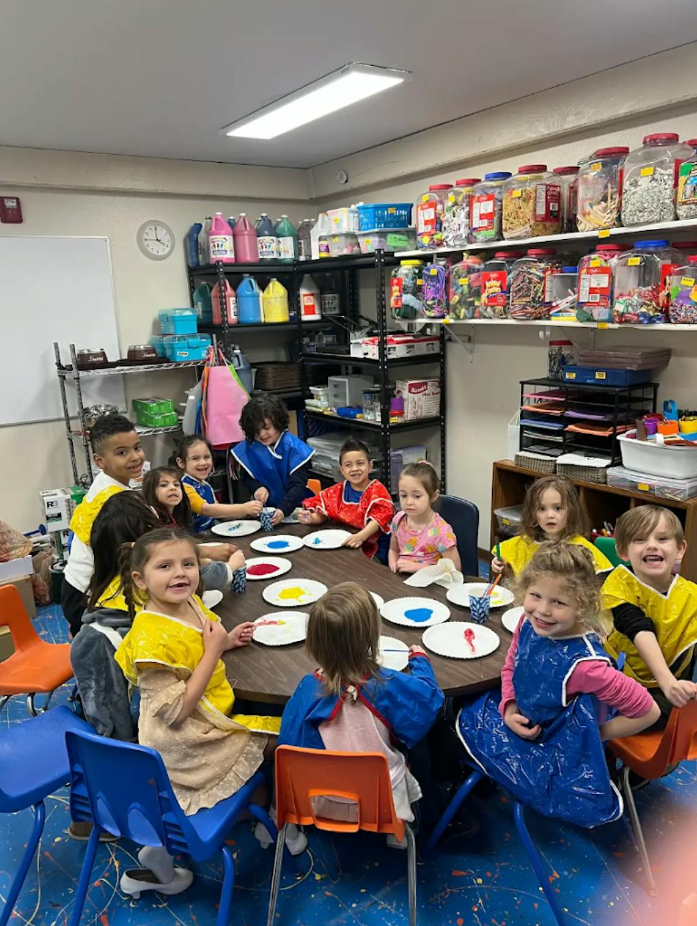 Group of children painting in a classroom