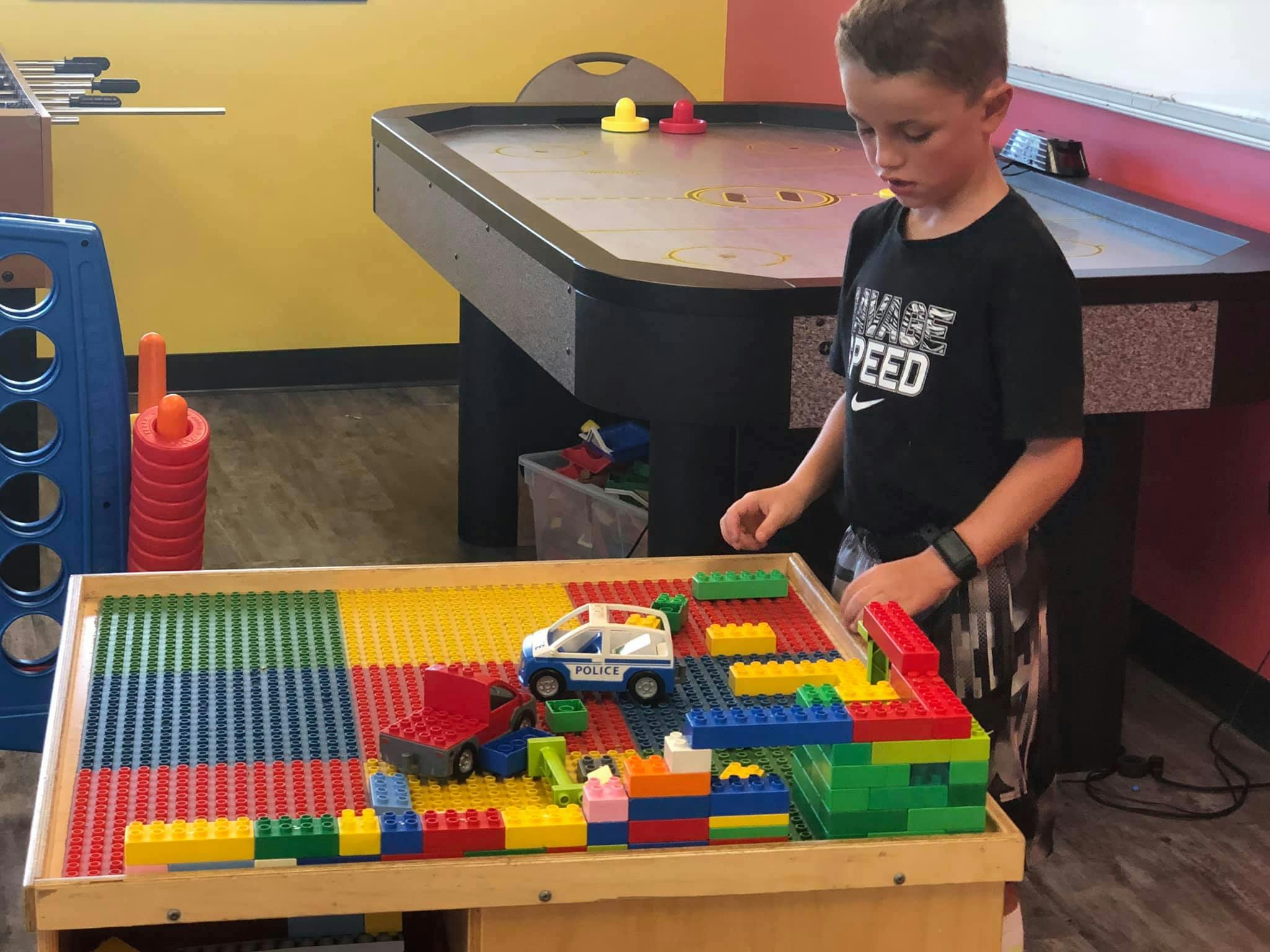 Child playing with building blocks on a table