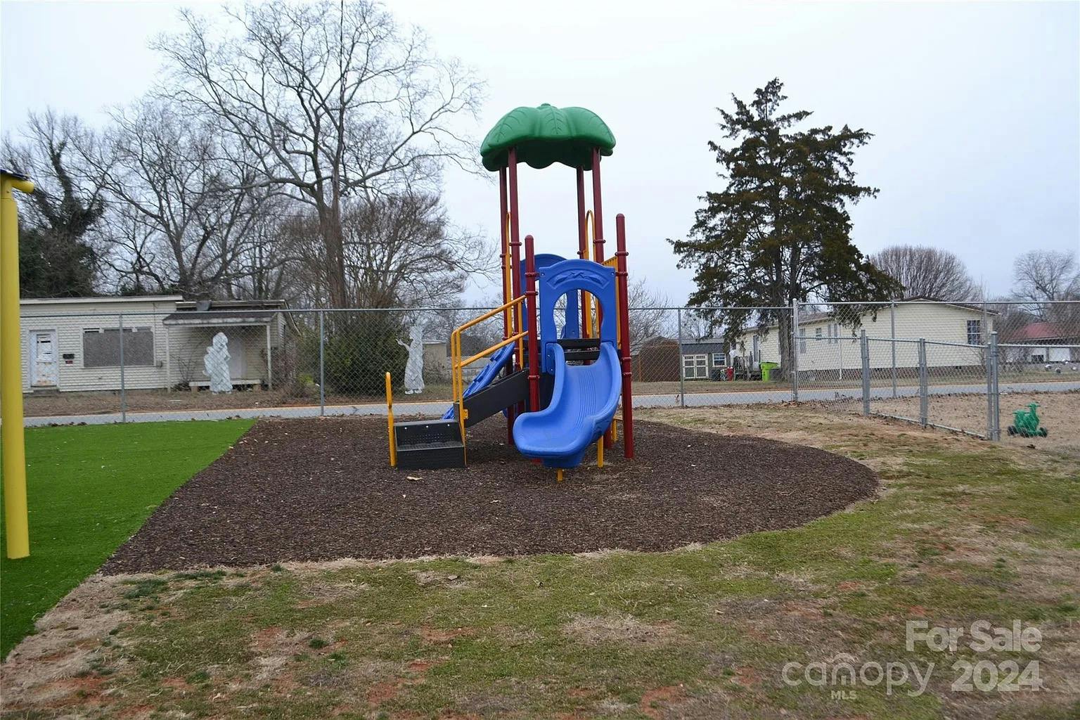 Playground with blue slide and green roof