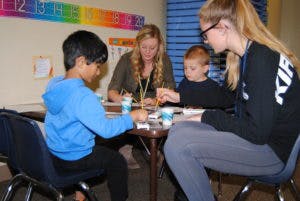 Two adults and two children at a table
