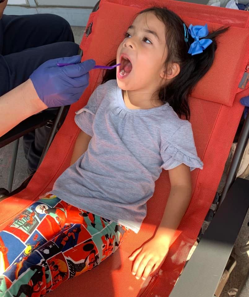 Child with mouth open for an oral examination