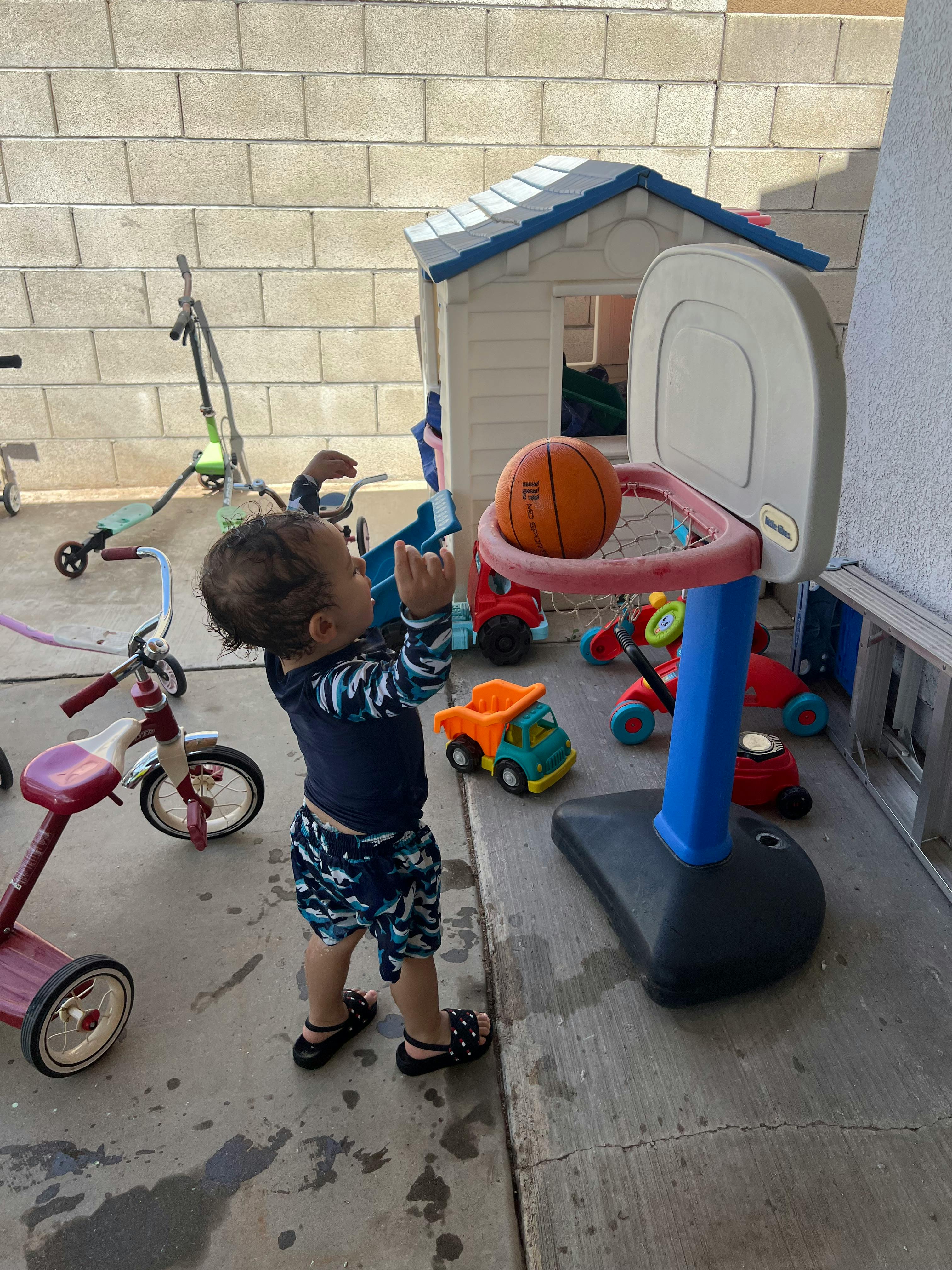 Child playing with a basketball hoop