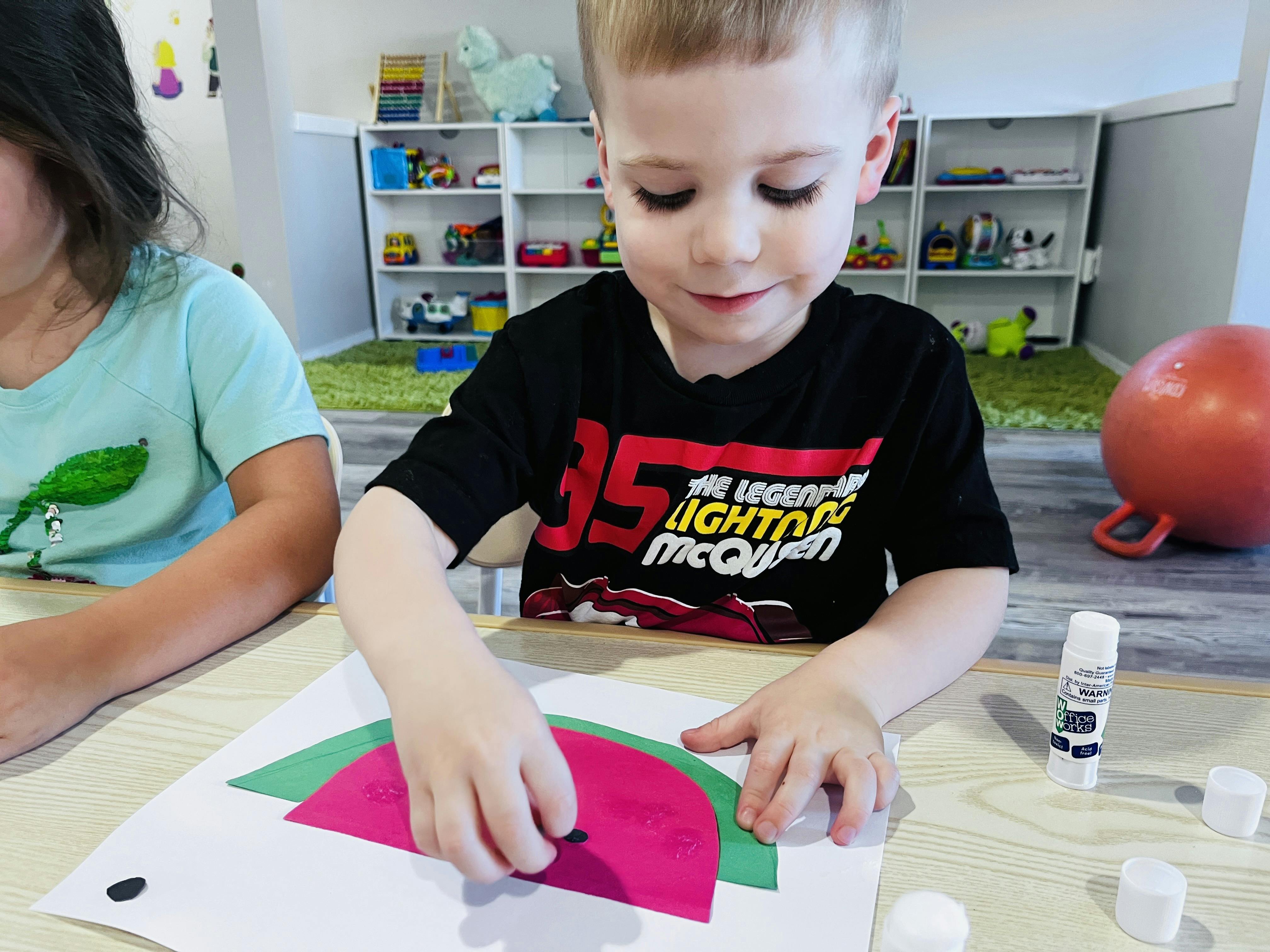 Child doing a craft at a table