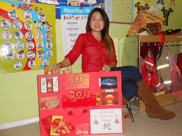 Person sitting with a red display board in front of them