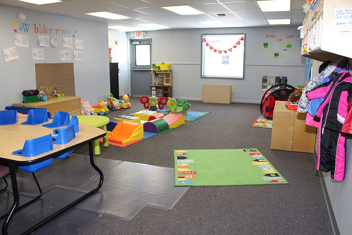 Playroom with colorful soft play equipment and small tables