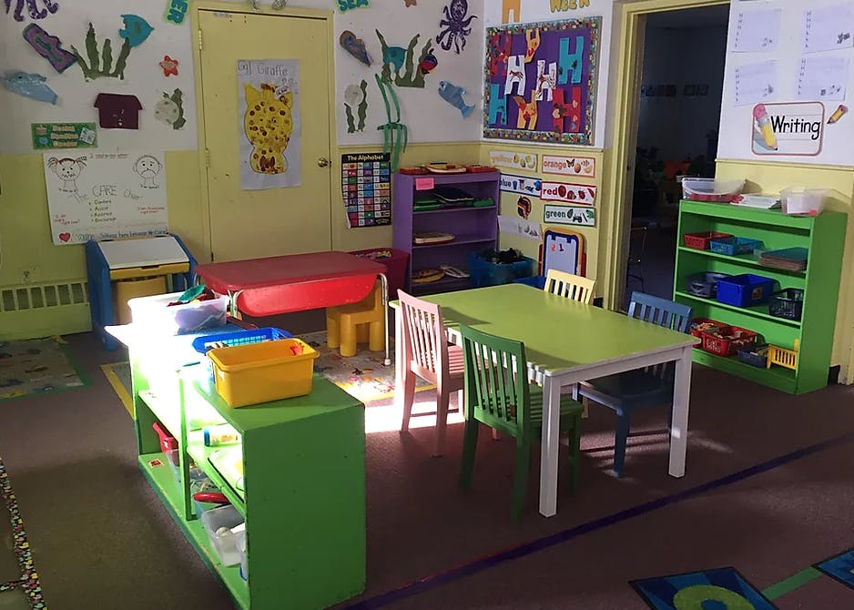 Empty classroom with small tables and chairs