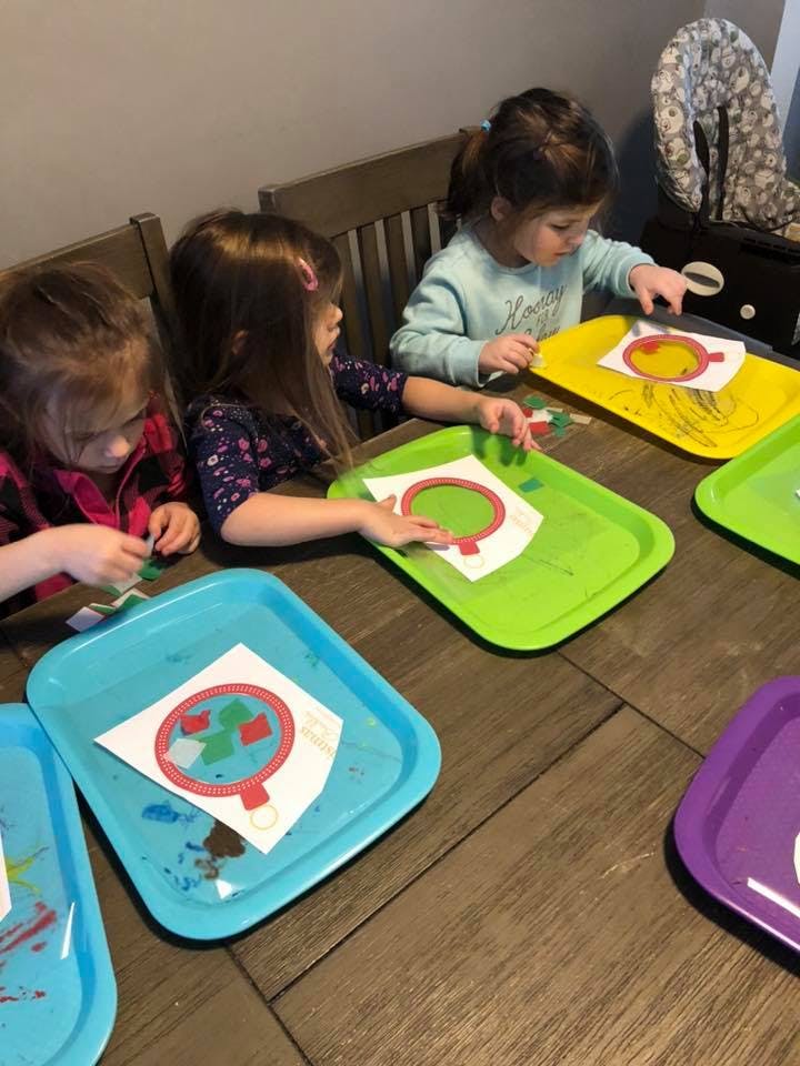Three children doing crafts at a table
