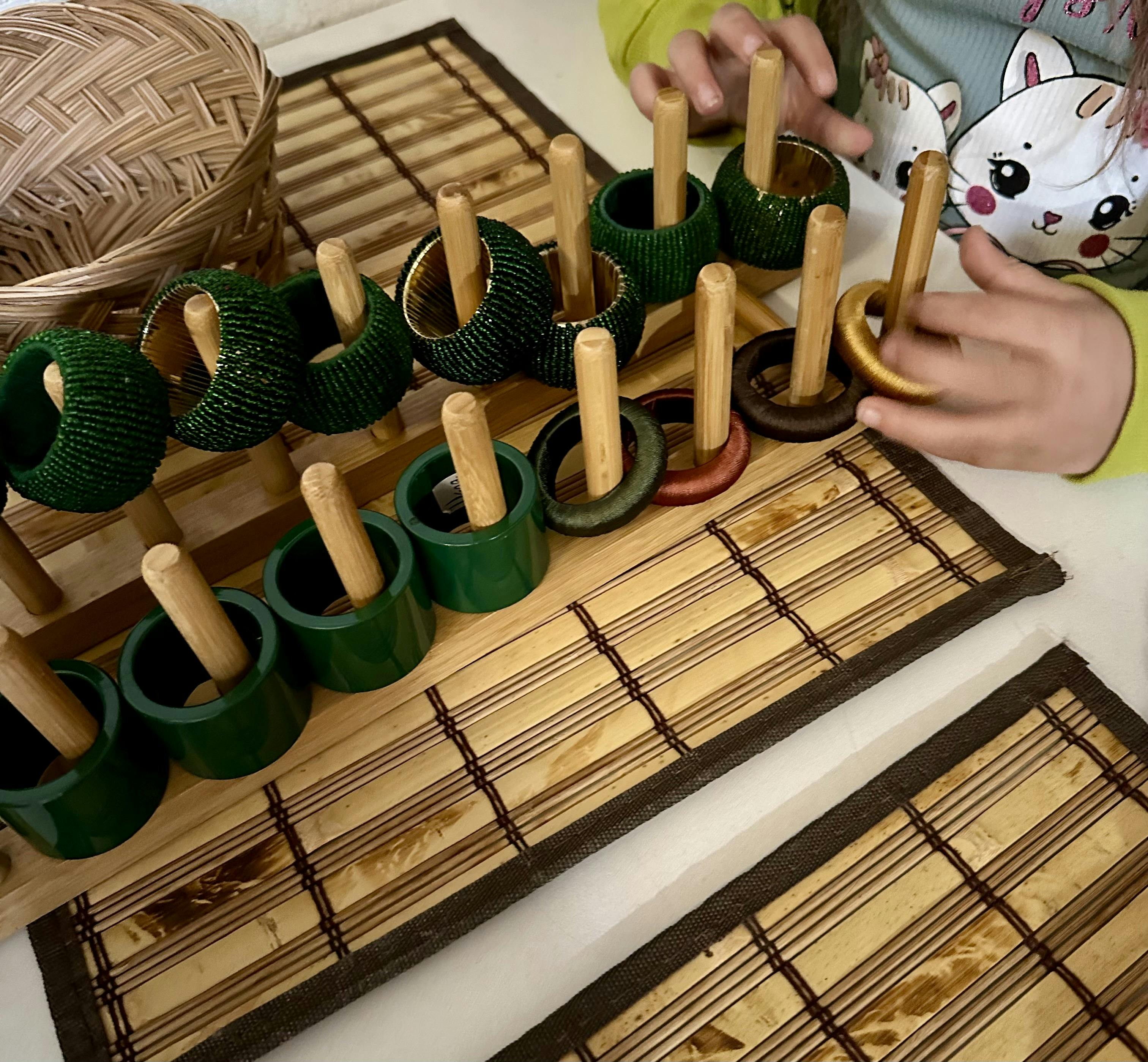 Child playing with a wooden ring toss game