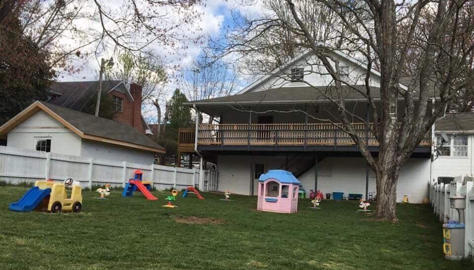 Backyard with play equipment and a house