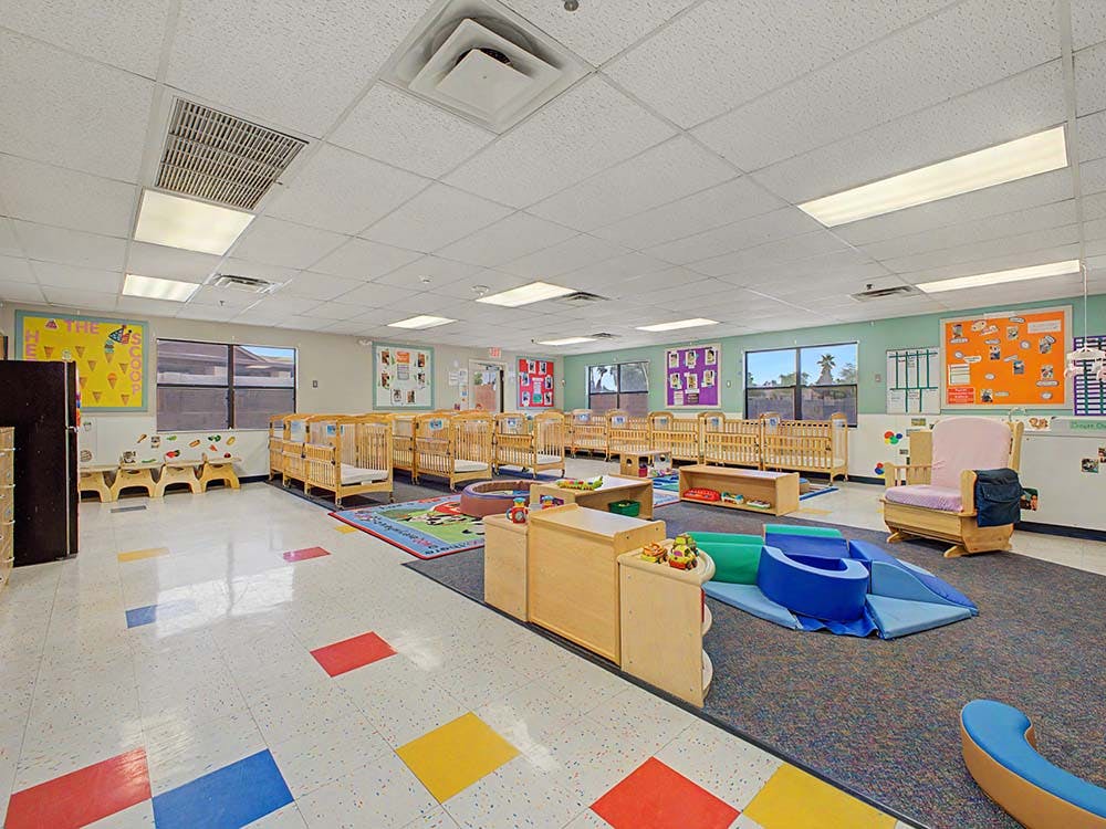 Cribs and play furniture in a childcare room