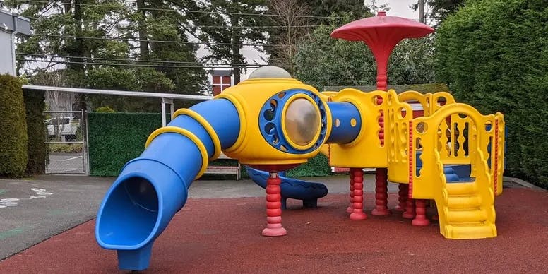 Playground with a yellow and blue slide structure
