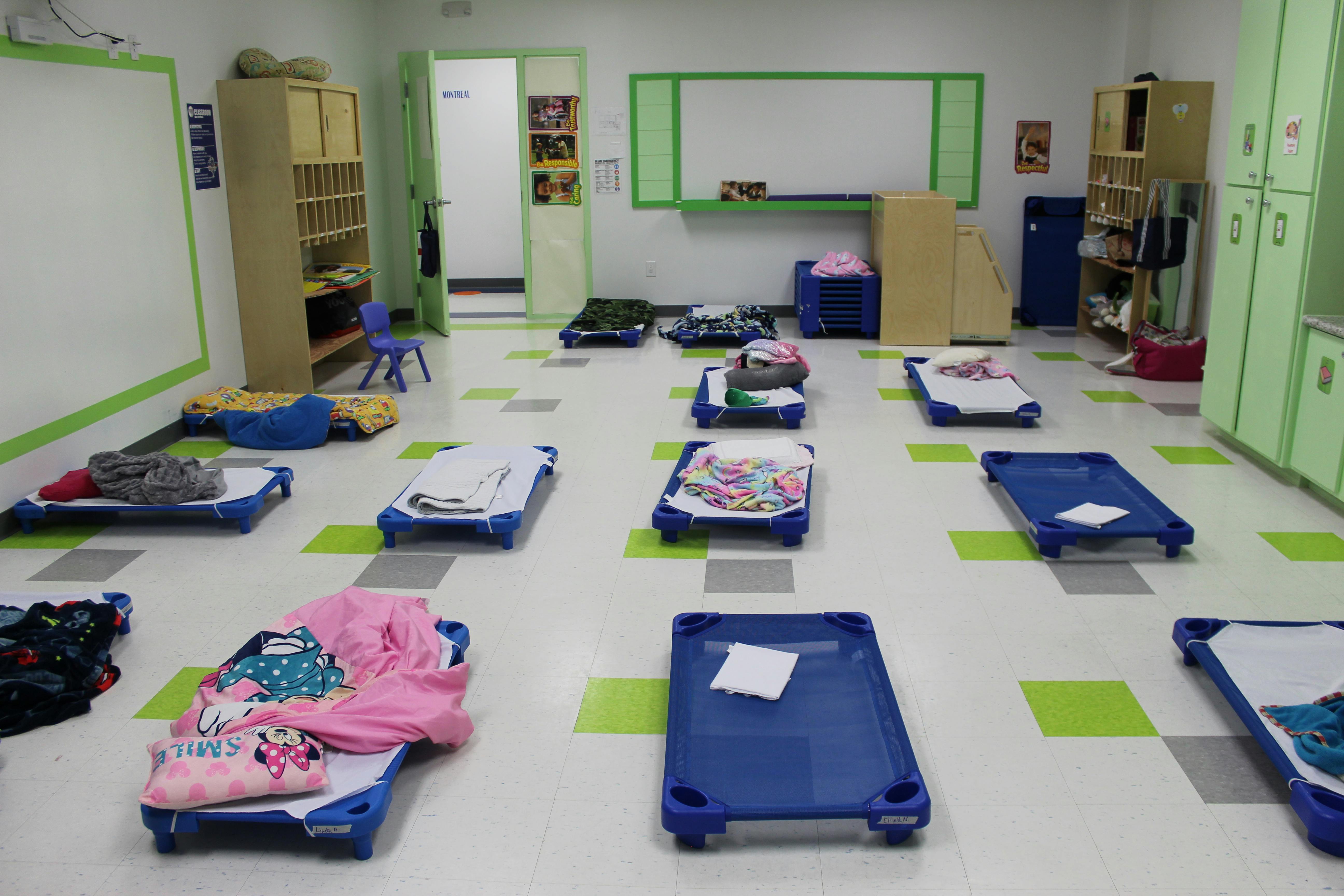 Empty cots in a daycare room