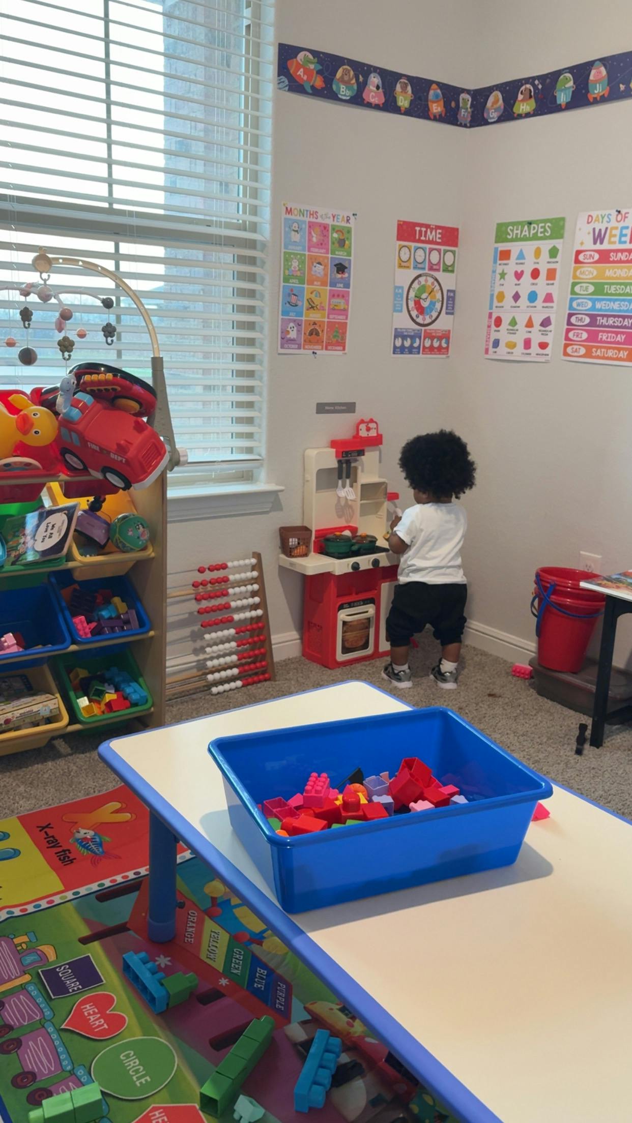 Child playing at a toy kitchen