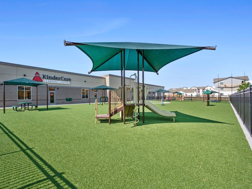 KinderCare Learning Centers building with outdoor play area with artificial turf