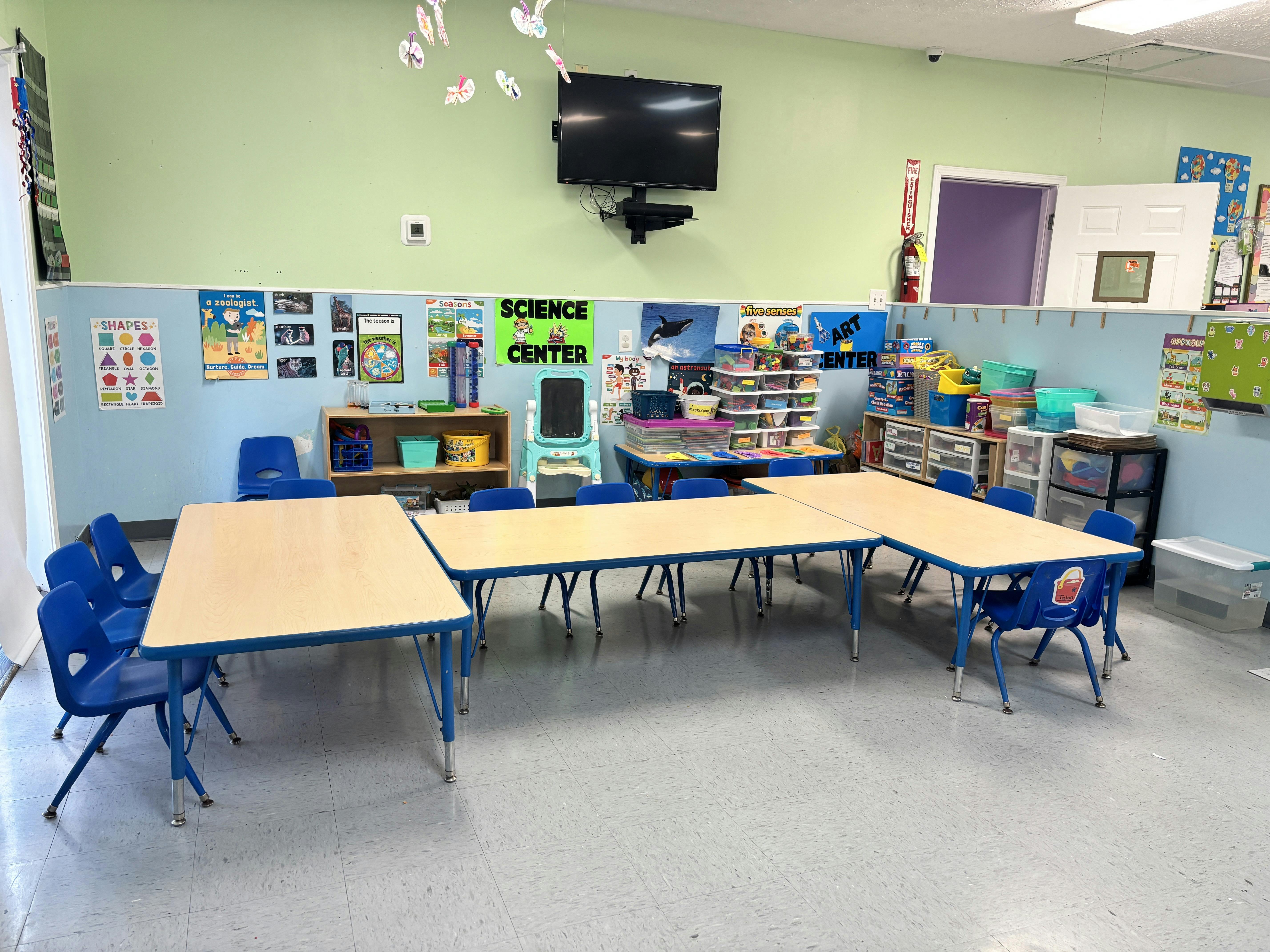 Classroom interior with tables and chairs arranged for group activities