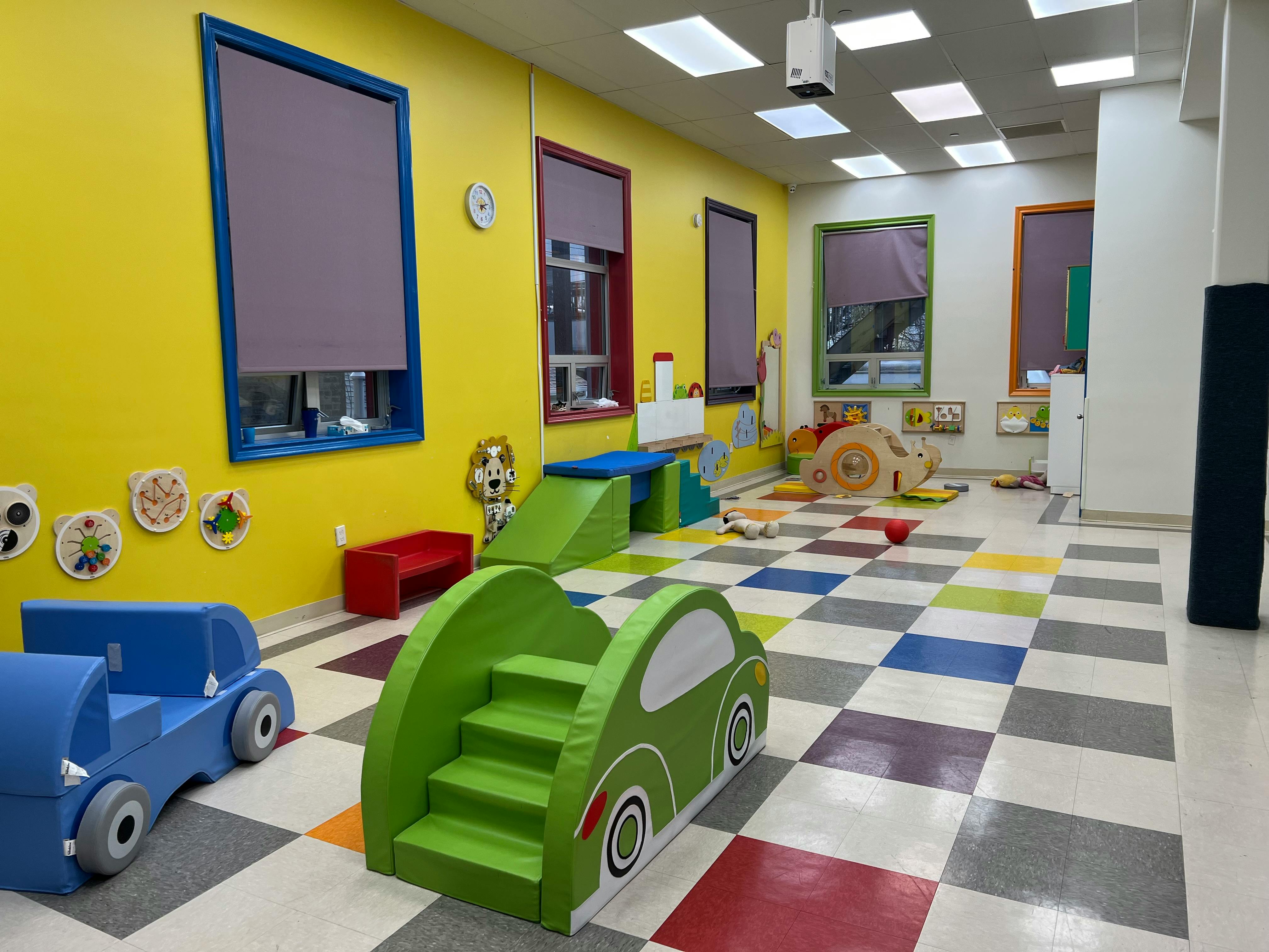 Indoor play area with soft play equipment and checkered floor