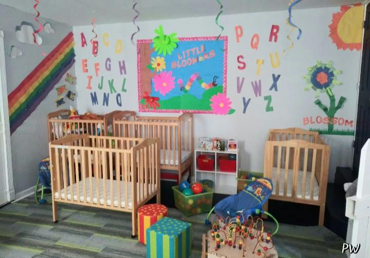 Cribs and learning decorations in a daycare room