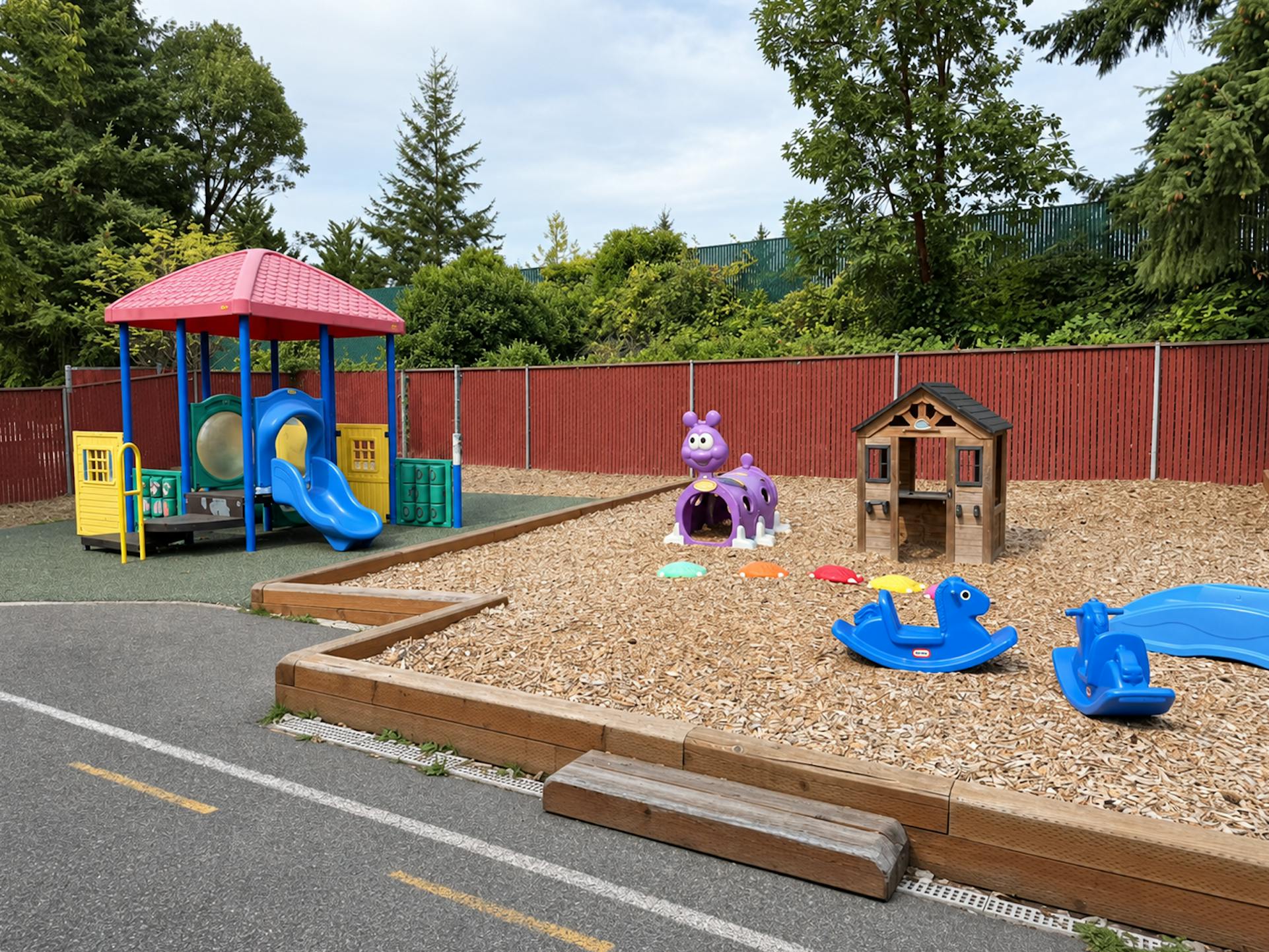Playground with climbing structure, play house, and rocker toys