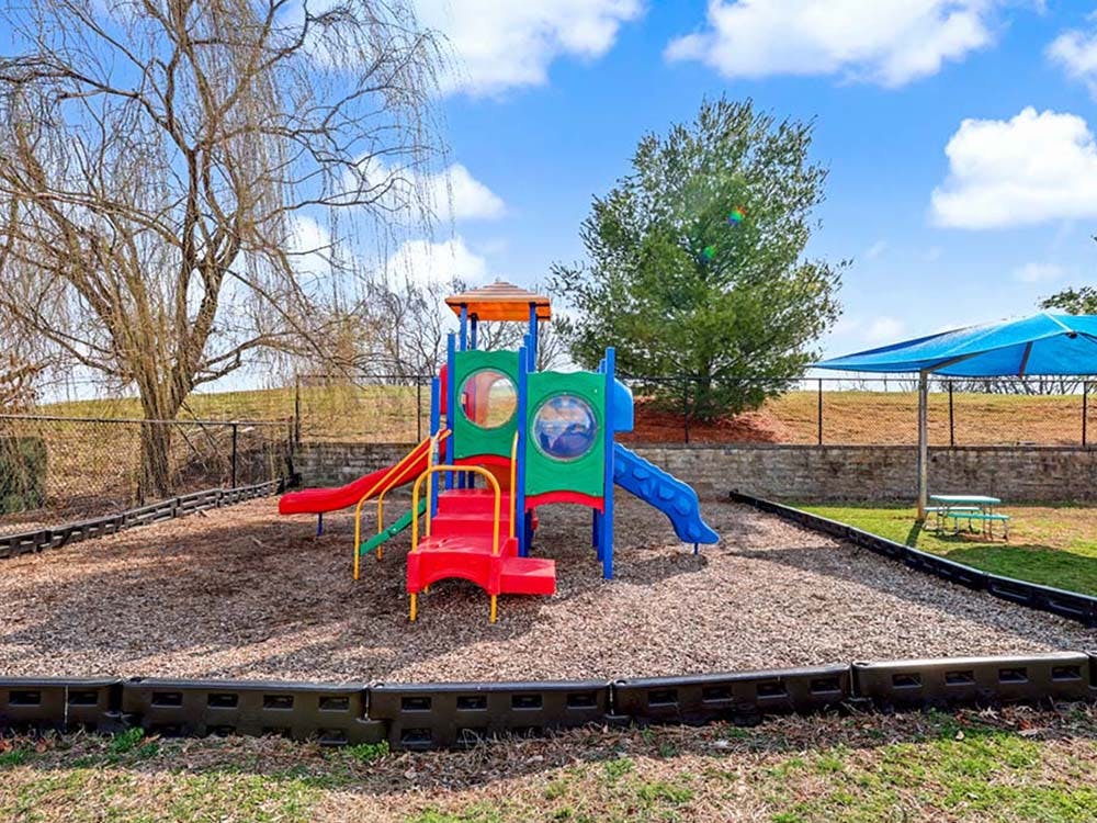 Colorful playground with multiple slides and a climbing structure