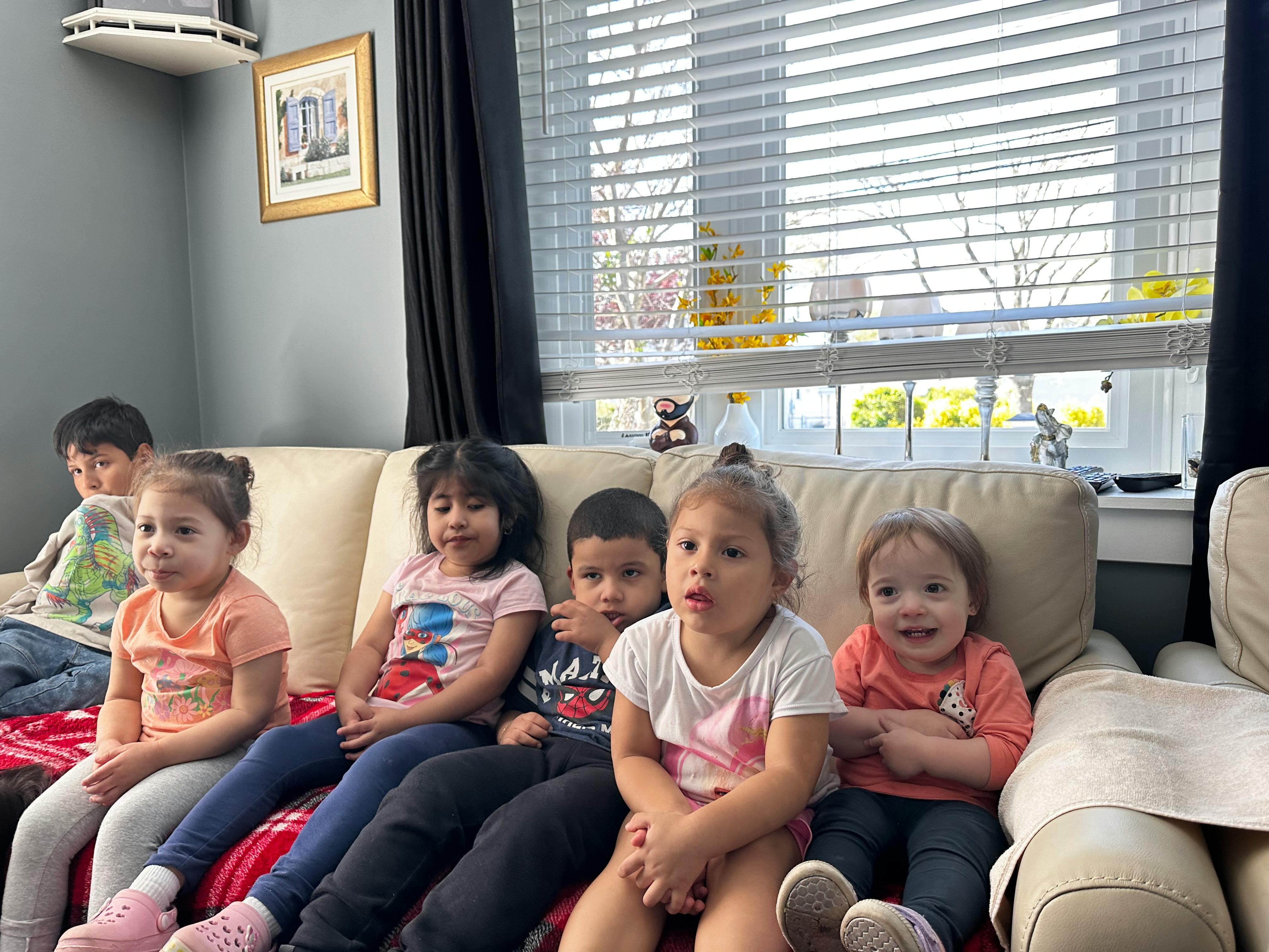 Five children sitting on a couch