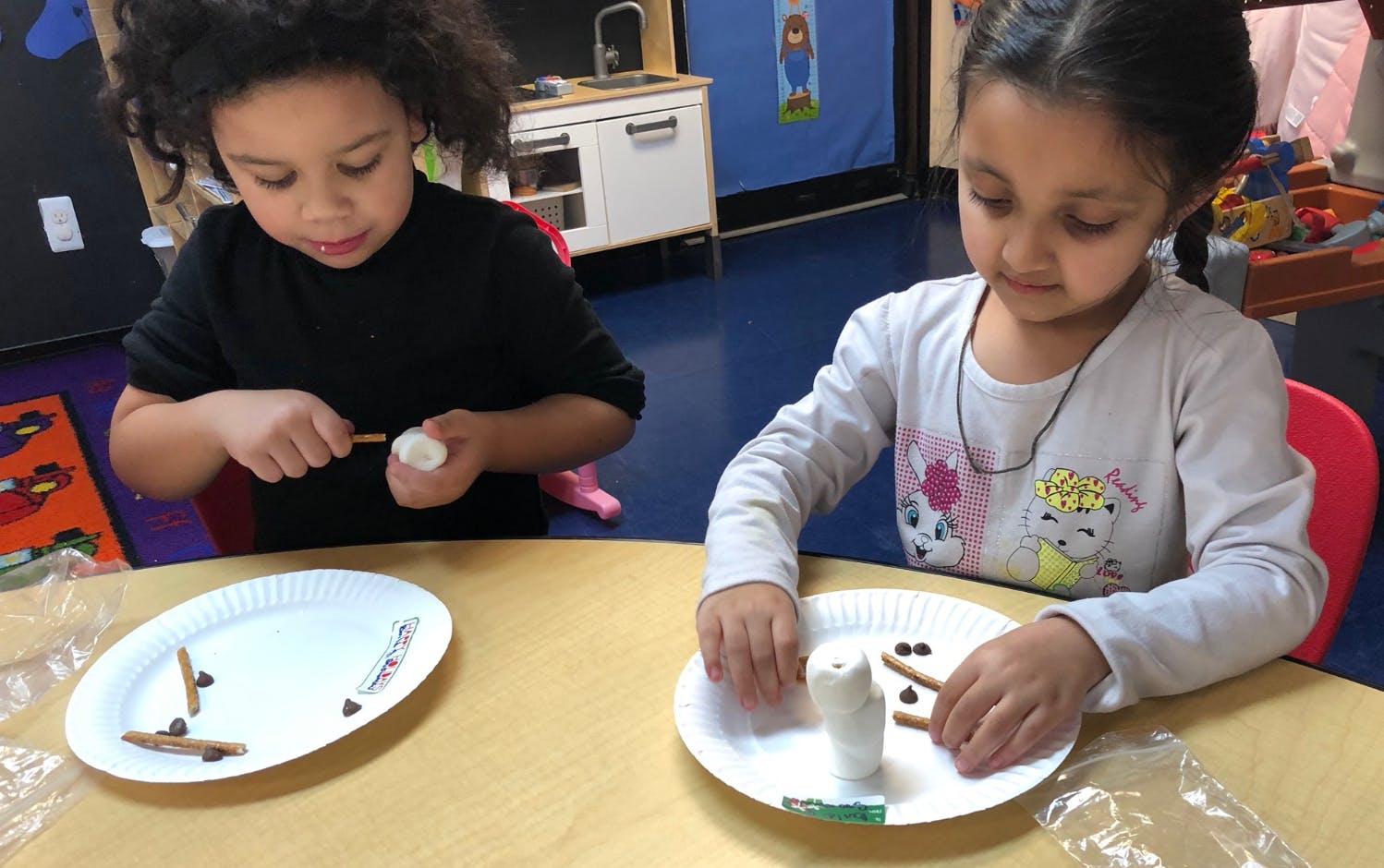 Two children making crafts at a table